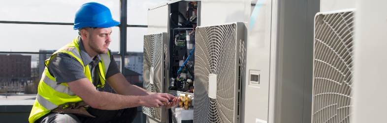 Tech Repairing Commercial Hvac System